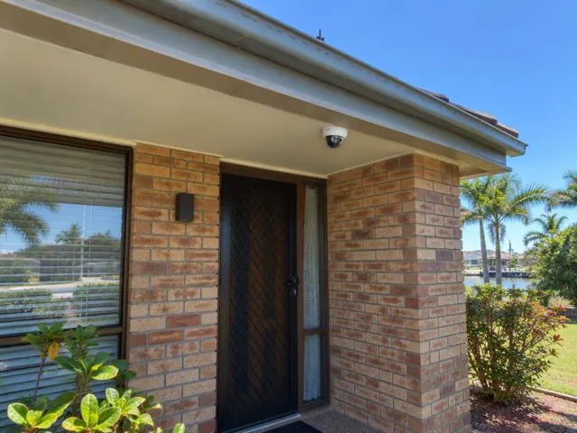 External CCTV dome camera under a brick house eave by the front door in Broadbeach Waters